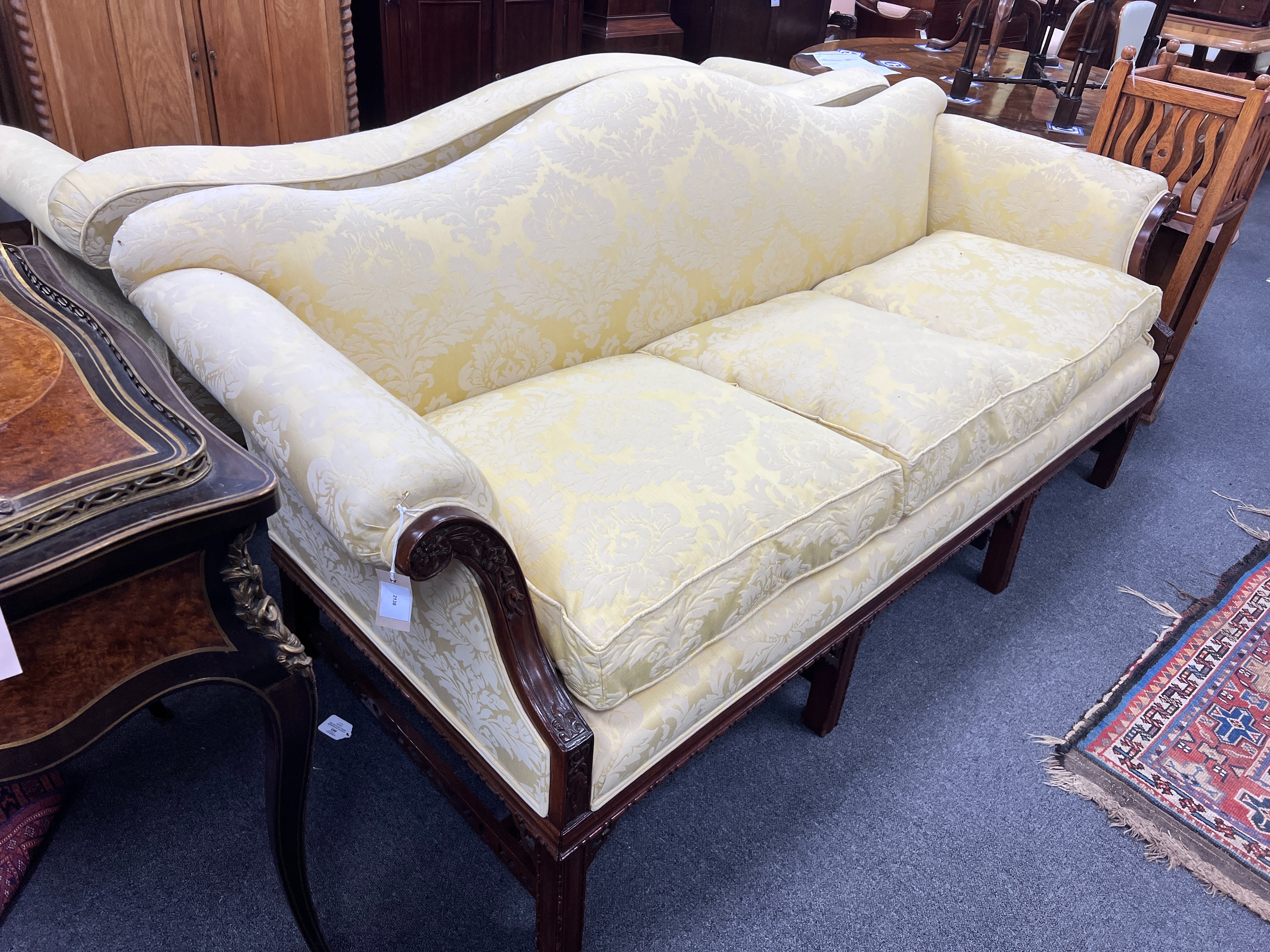 A pair of early 20th century Chippendale revival mahogany three seater settees upholstered in a patterned gold damask, length 206cm, depth 78cm, height 88cm